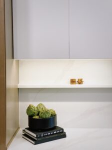Artichokes In Black Bowl On Stack Of Books In Kitchen