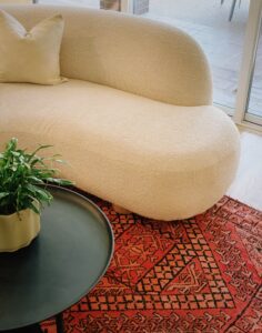 Beige Sofa On Black Red Orange Area Rug