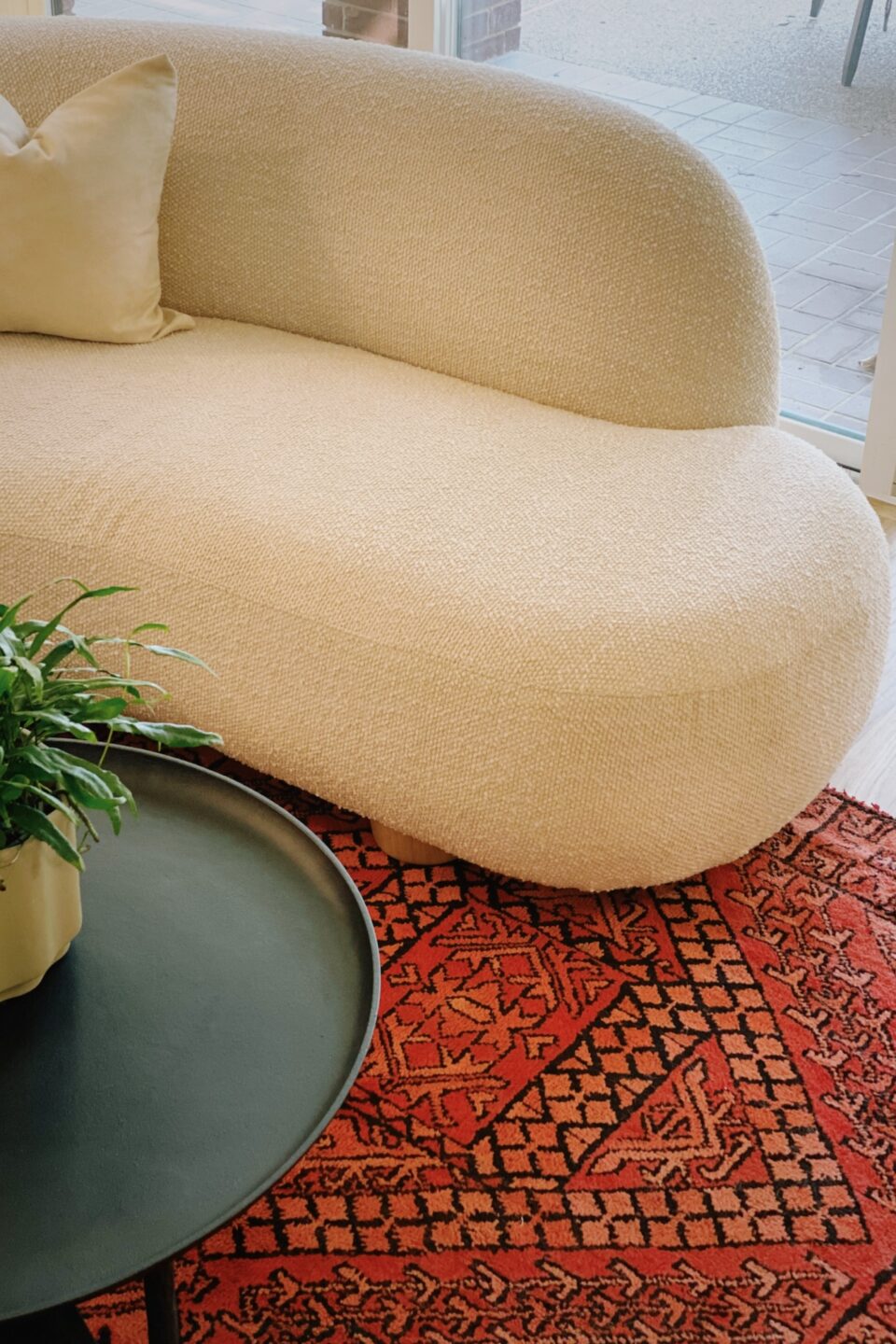 Beige Sofa On Black Red Orange Area Rug