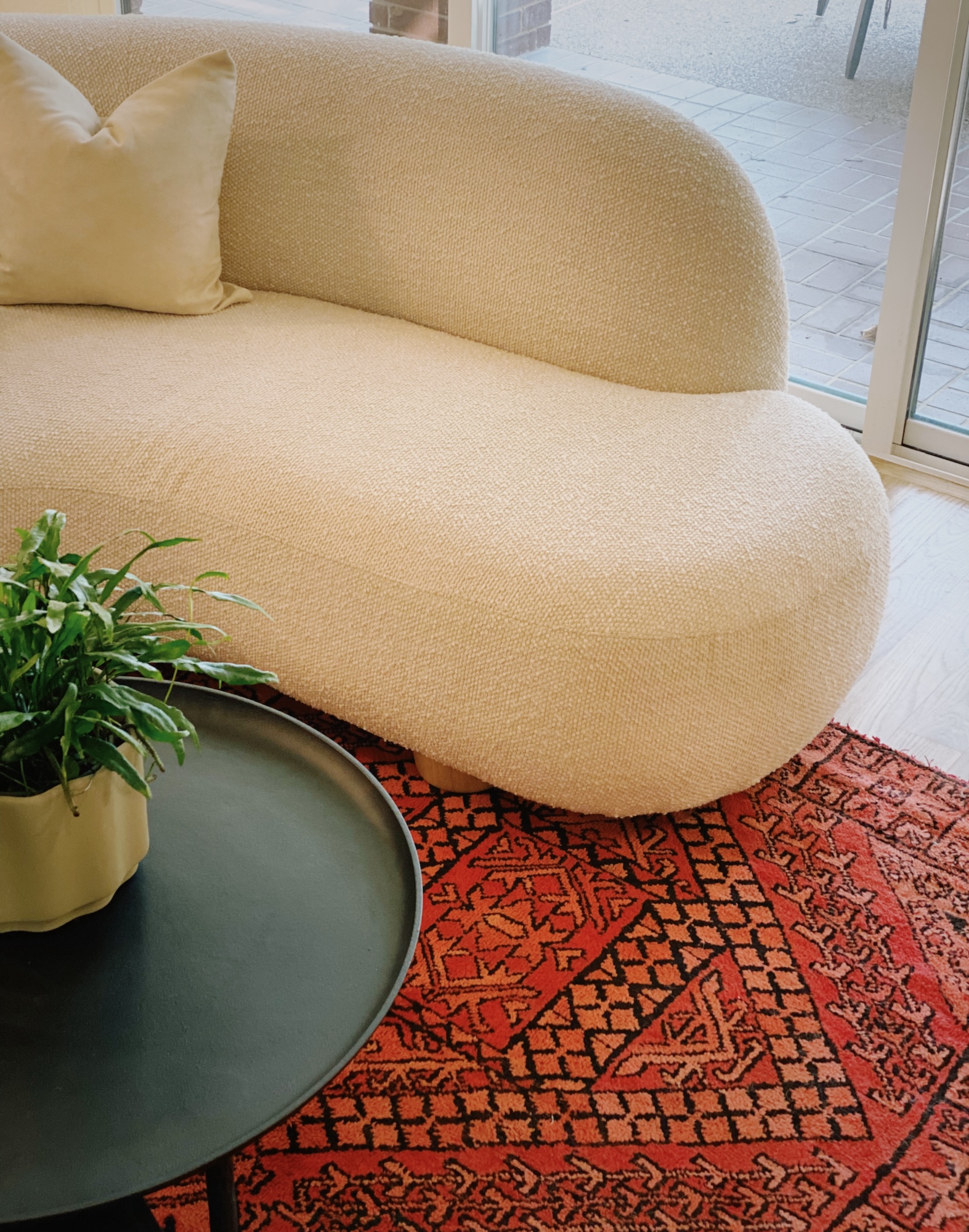 Beige Sofa On Black Red Orange Area Rug